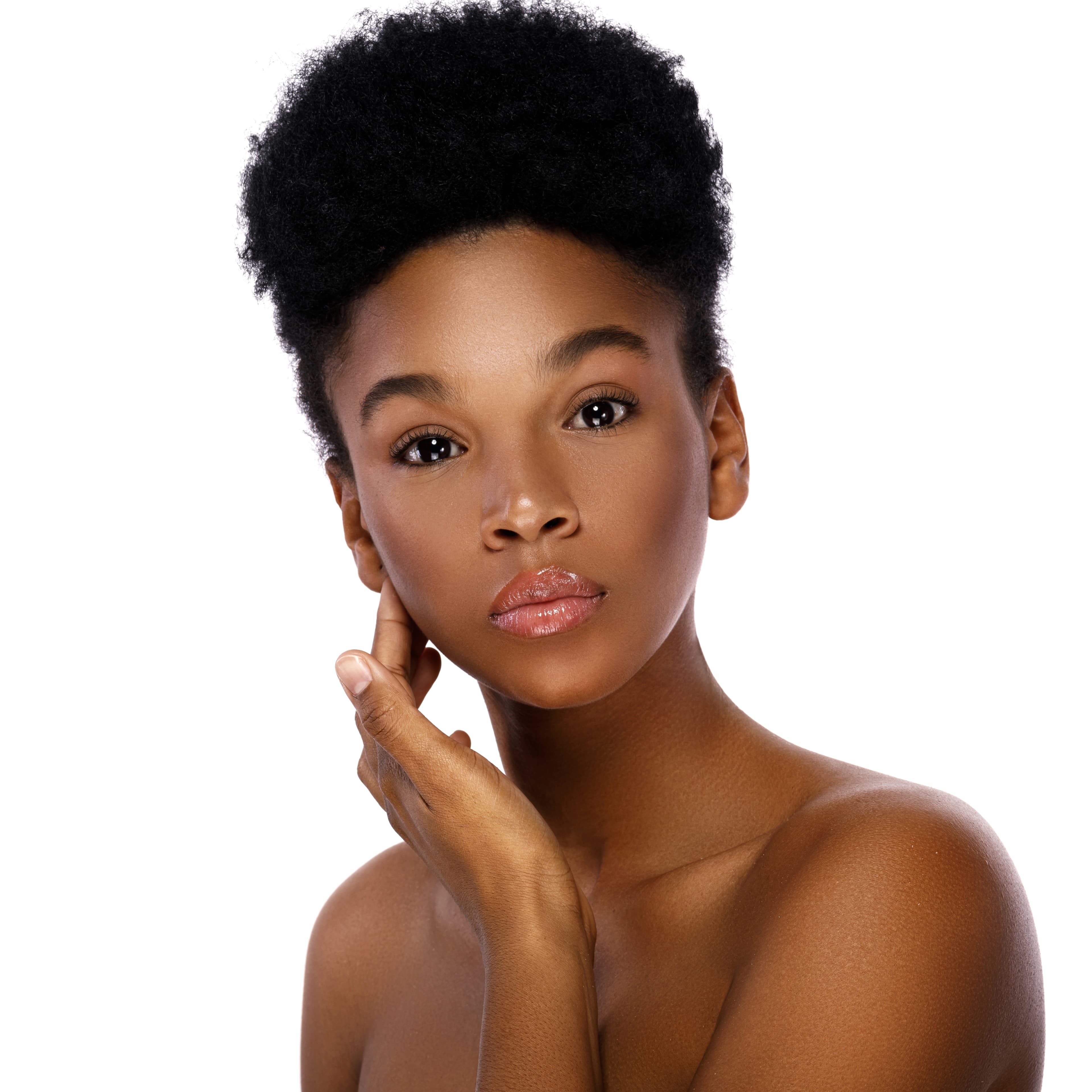 Woman with melanin-rich skin looking calm and confident